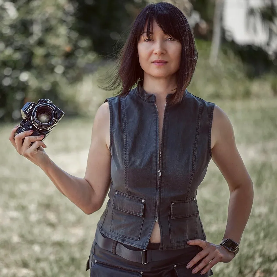 Yuliya Panchenko holding a Nikon F3 analog film camera